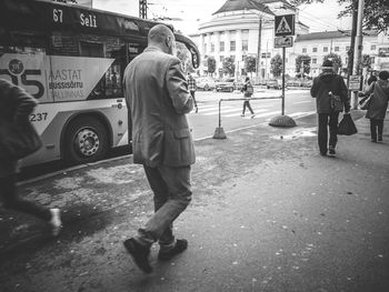 Man standing on road in city