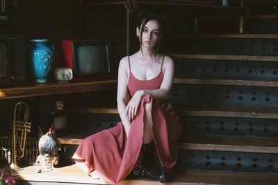 Portrait of young woman sitting on steps