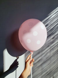 Midsection of person holding balloons
