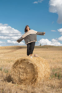 Hay bales on field against sky