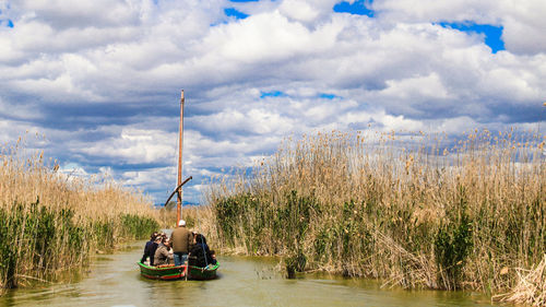 Boat sailing in river against sky