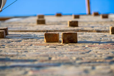 Close-up of wood against blue sky on sunny day