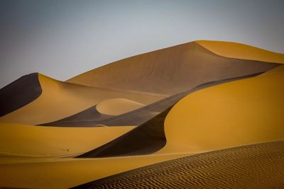 Low angle view of desert against clear sky