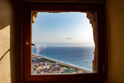 Scenic view of sea seen through window