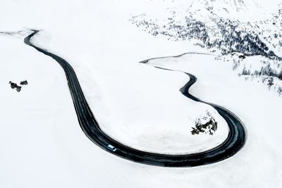 High angle view of winding road on snowcapped mountains