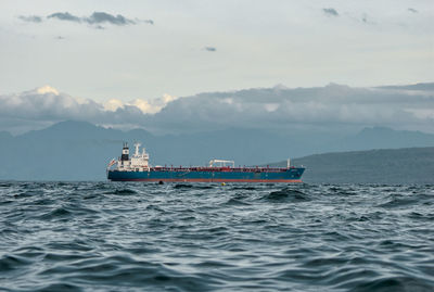 Ship sailing on sea against sky