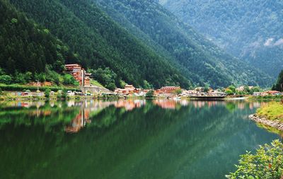 Scenic view of lake by trees and mountains