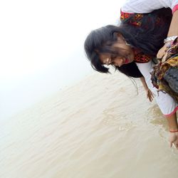 Rear view of women walking on beach