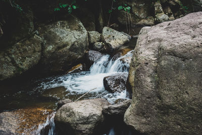 Stream flowing through rocks in forest