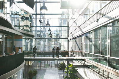 Business people standing in atrium at modern office