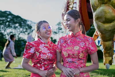 Happy chinese new year. asian woman wearing traditional cheongsam qipao dress.