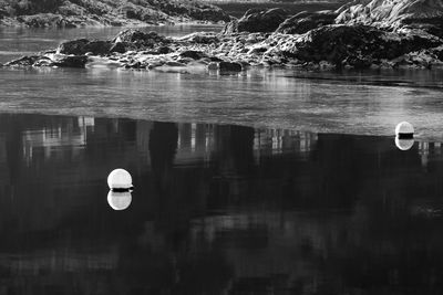 Buoys floating on frozen river