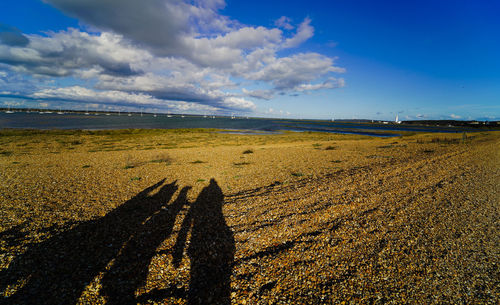 Shadows of people on beach