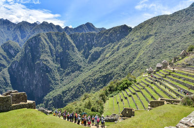 Panoramic view of people on mountain against sky