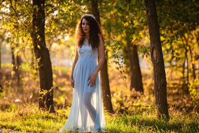 Portrait of woman standing in forest