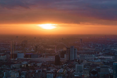 Aerial view of buildings against sky during sunset