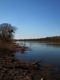 Scenic view of lake against clear blue sky