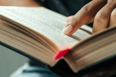 Close-up of hand holding book