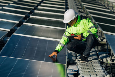The portrait of a male engineer checks photovoltaic solar panels