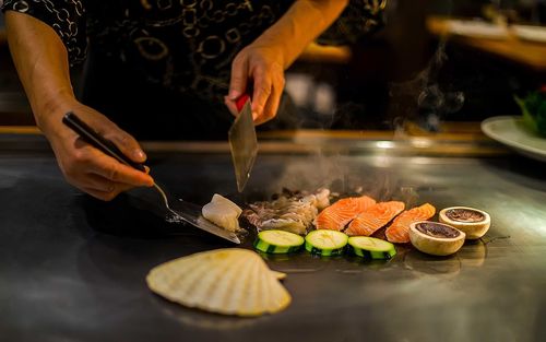 Midsection of person preparing food in kitchen