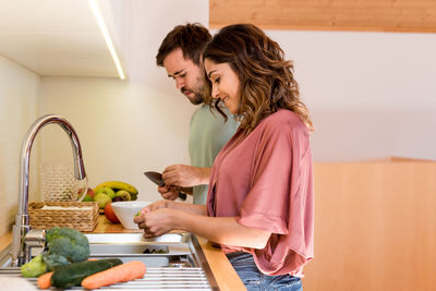 Couple preparing food together in kitchen at home