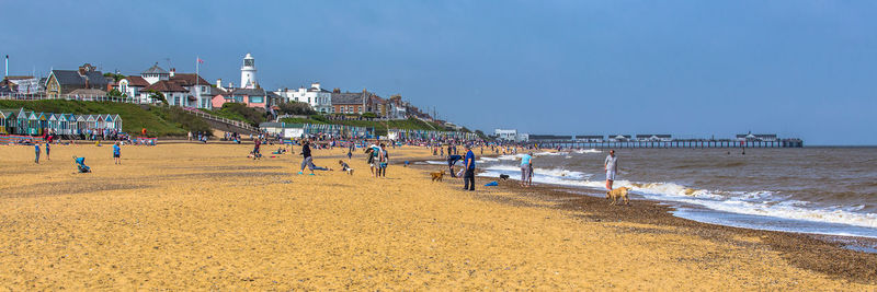 People at beach against sky