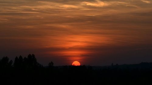 Silhouette of landscape against dramatic sky