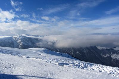 Scenic view of snowcapped mountains against sky