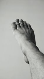 Low section of man against white background