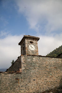 Low angle view of clock tower against sky