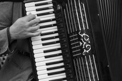 Close-up of man playing piano