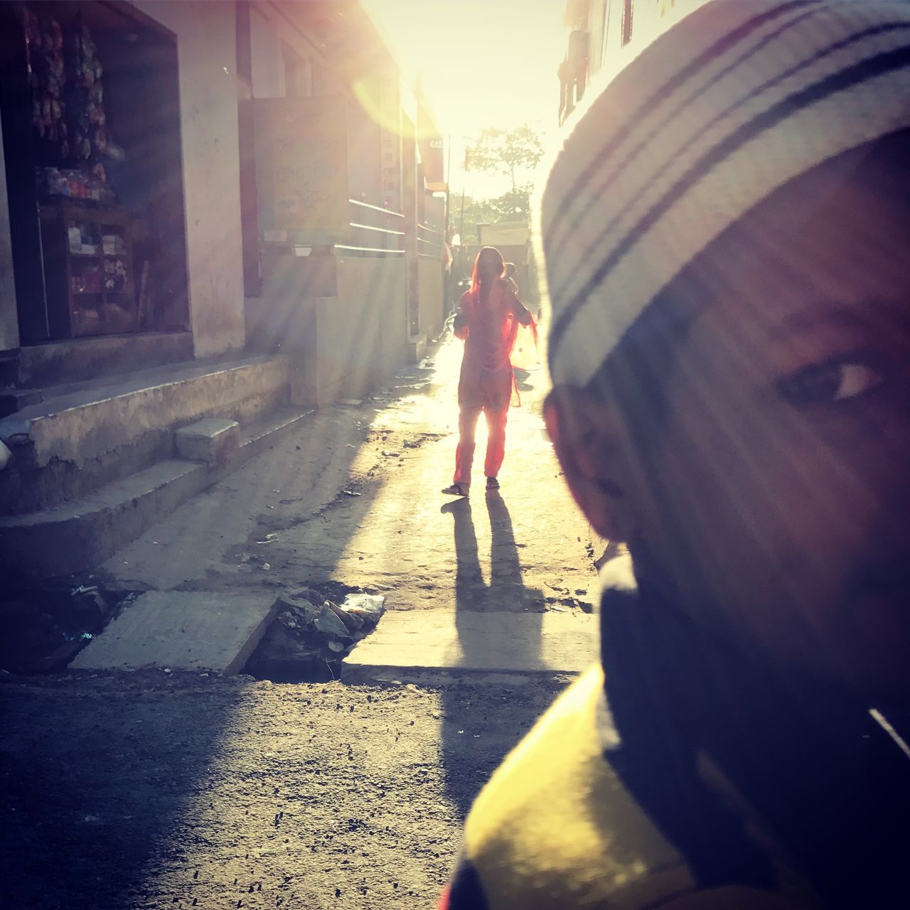 sunlight, street, two people, building exterior, walking, built structure, outdoors, city, real people, road, architecture, shadow, day, full length, men, women, people