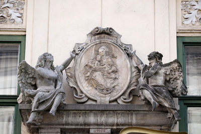 Low angle view of statue against historic building