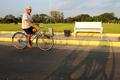 Side view of man riding bicycle