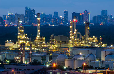 Illuminated cityscape against sky at night