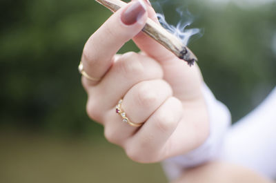 Close-up of hand holding marijuana joint