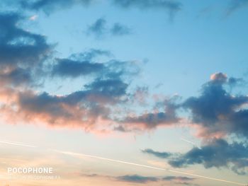 Low angle view of airplane against sky during sunset