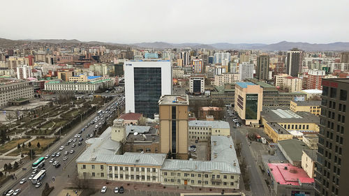 High angle view of buildings in city against sky