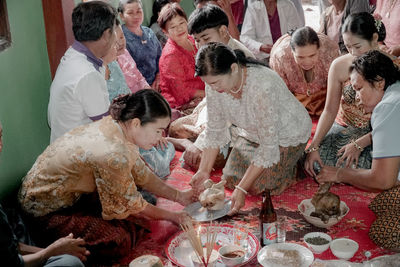 High angle view of people sitting on table