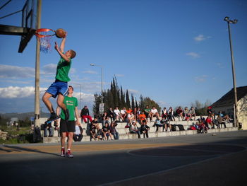 People playing football on road