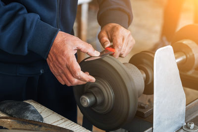 Midsection of man working in workshop