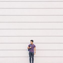 Young woman standing by railing