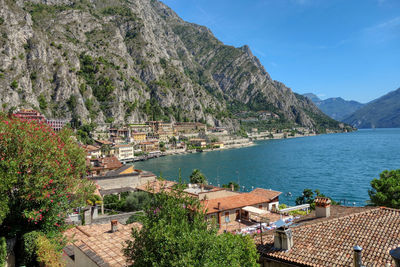 Scenic view of town by sea against sky
