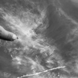 Low angle view of person paragliding against sky