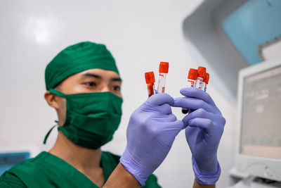 Midsection of doctor examining patient at clinic