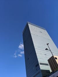 Low angle view of modern buildings against clear blue sky