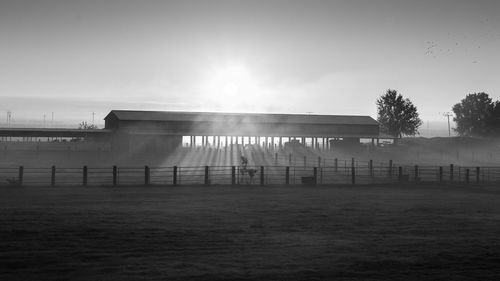 Barn against sky during sunrise