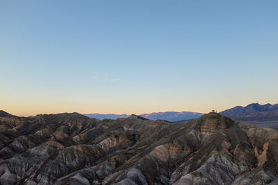 Scenic view of mountains against clear sky during sunset