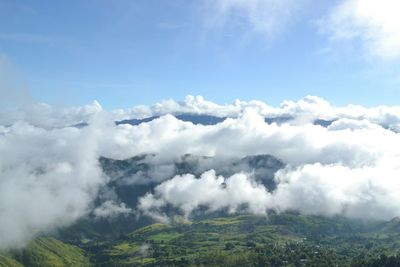 Scenic view of clouds over mountains against sky