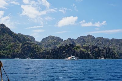 Scenic view of sea and mountains against sky